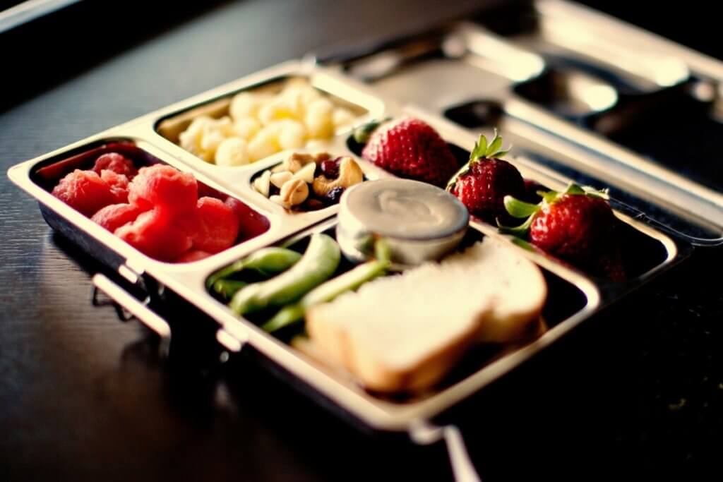 A metal bento box lunch tray packed with healthy snack ideas ideal for kids