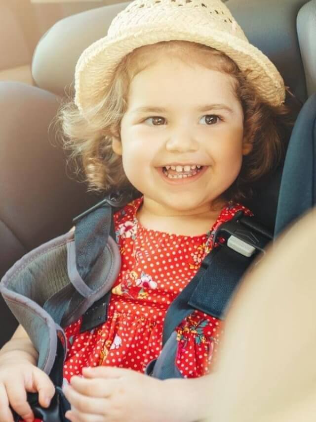 smiling girl in a car seat