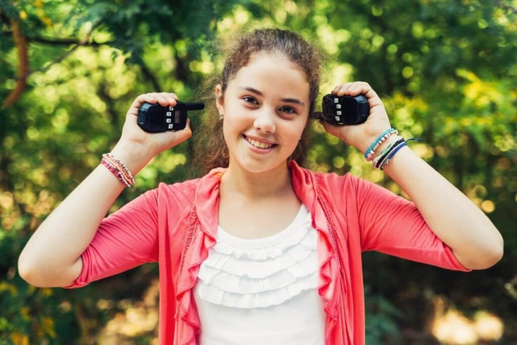 Girl holding two walkie talkies