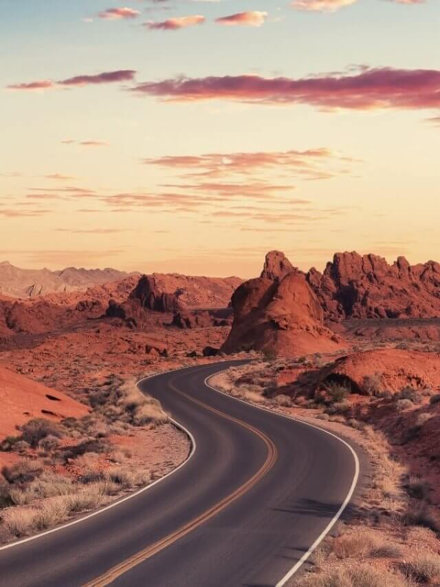 a winding road through the valley of fire in Nevada at sunset