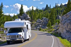 an rv truck driving through mountain road