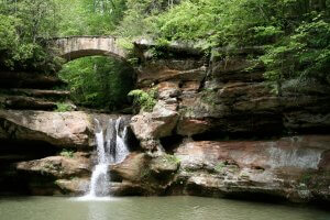 hocking hills state park in ohio, waterfall surrounded by lush greenery in the spring