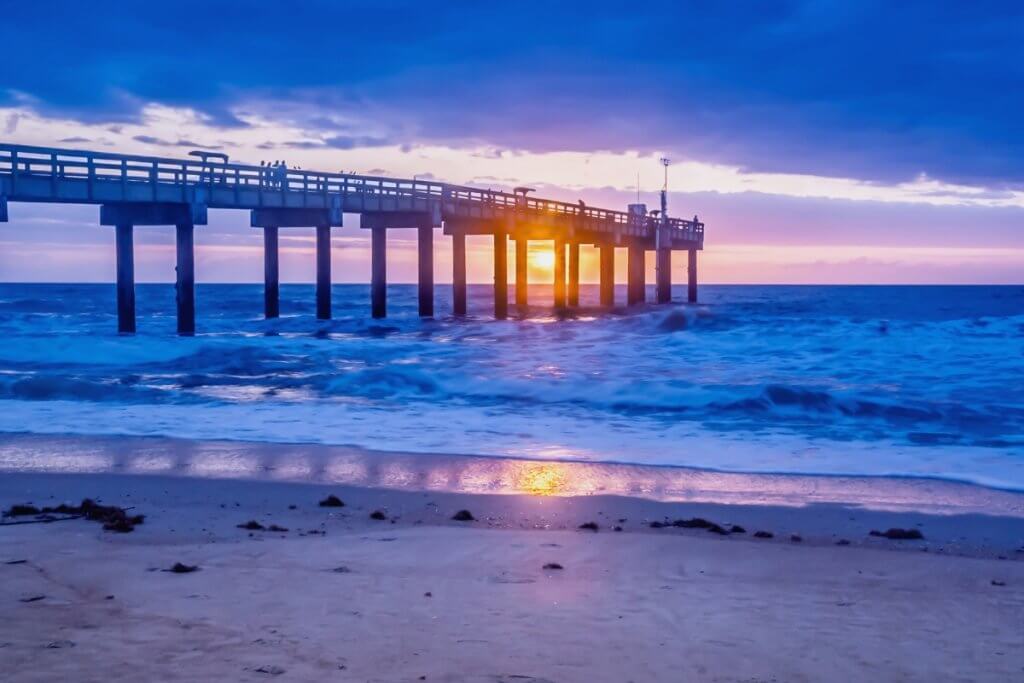 long pier into the atlantic ocean at sunrise in st augustine