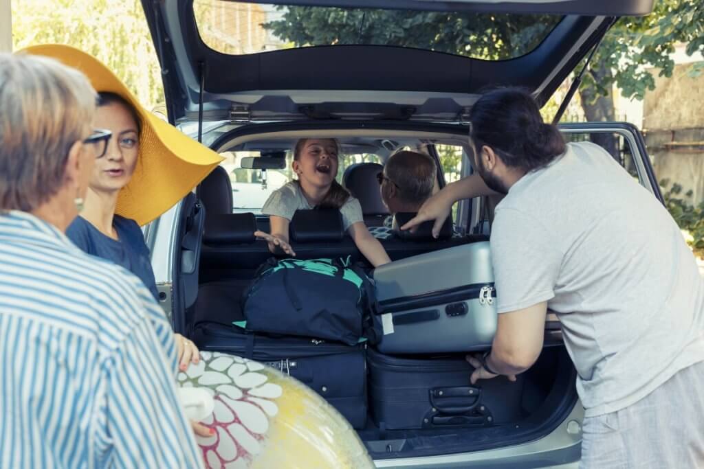 family packing the trunk of an SUV car